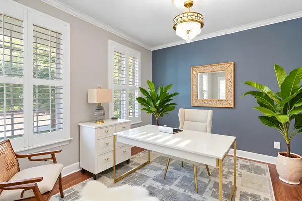 a workspace with furniture window and wooden floor