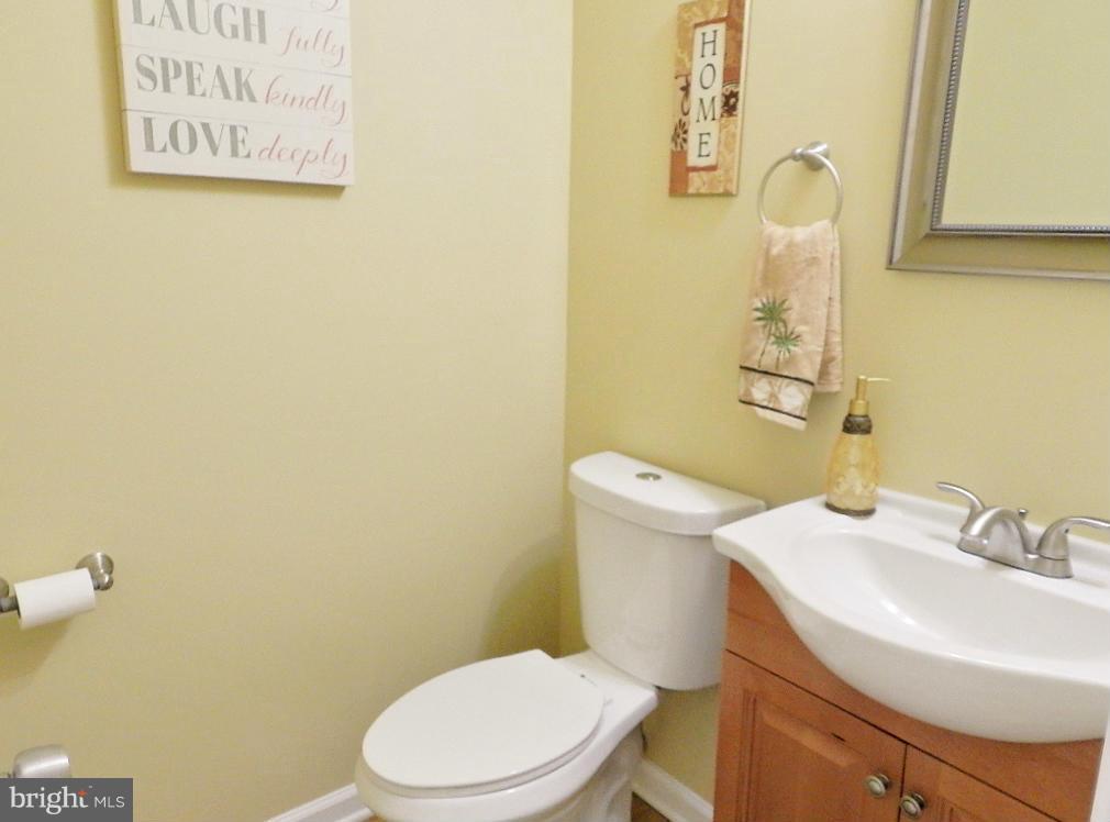 8991 Centerway Road Gaithersburg, MD 20879 - Photo 22 of 30 a white toilet sitting next to a bathroom sink