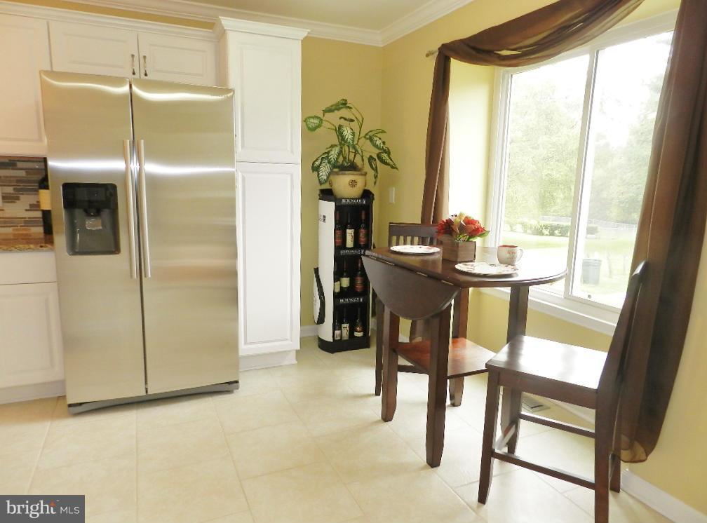 8991 Centerway Road Gaithersburg, MD 20879 - Photo 8 of 30 a view of a dining room with furniture window and outside view