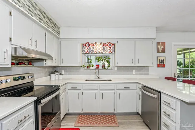 a kitchen with a sink stove and cabinets