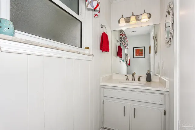a bathroom with a sink vanity and mirror