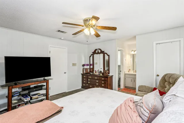 a bedroom with furniture and a flat screen tv
