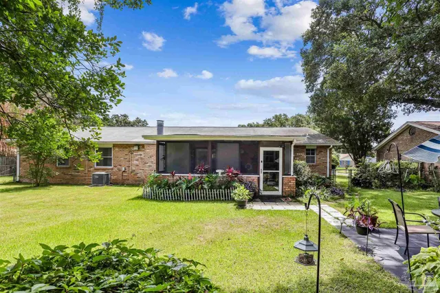 a front view of house with yard and outdoor seating
