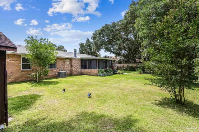 a backyard of a house with table and chairs