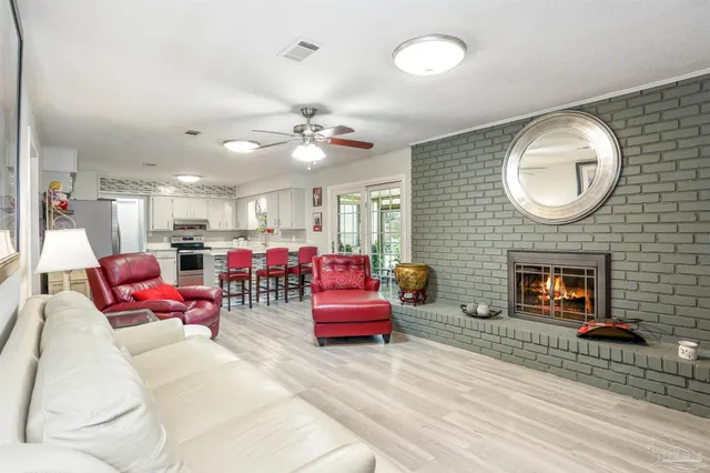 a living room with furniture kitchen view and a fireplace