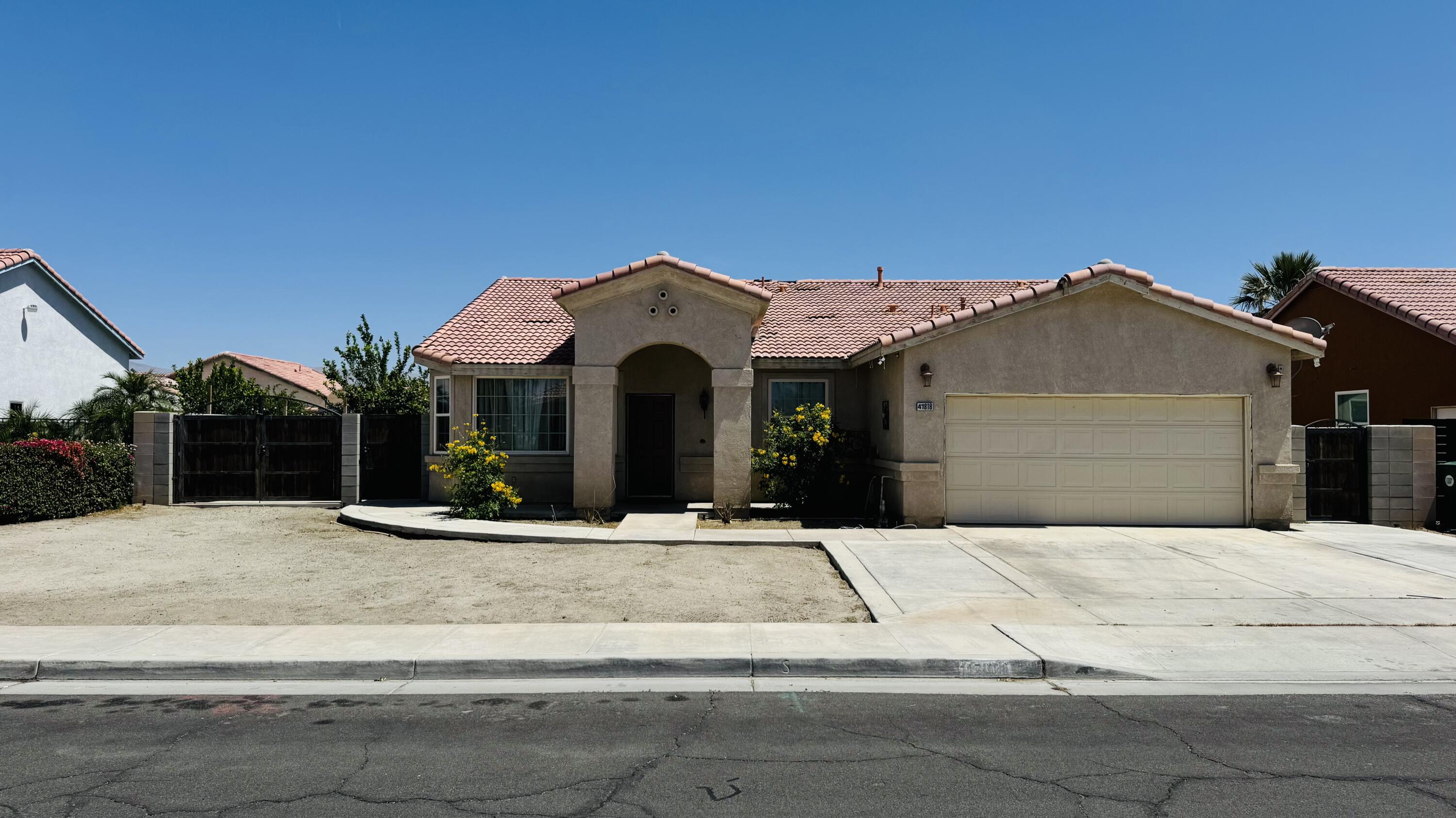 47818 Phoenix Street Indio, CA 92201 - Photo 1 of 14 a front view of a house with yard