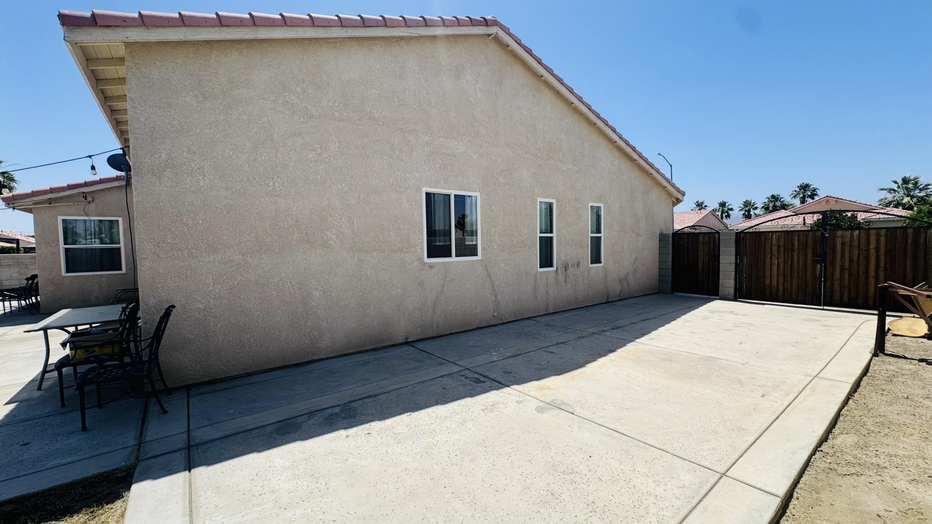 47818 Phoenix Street Indio, CA 92201 - Photo 12 of 14 a view of a house with a backyard