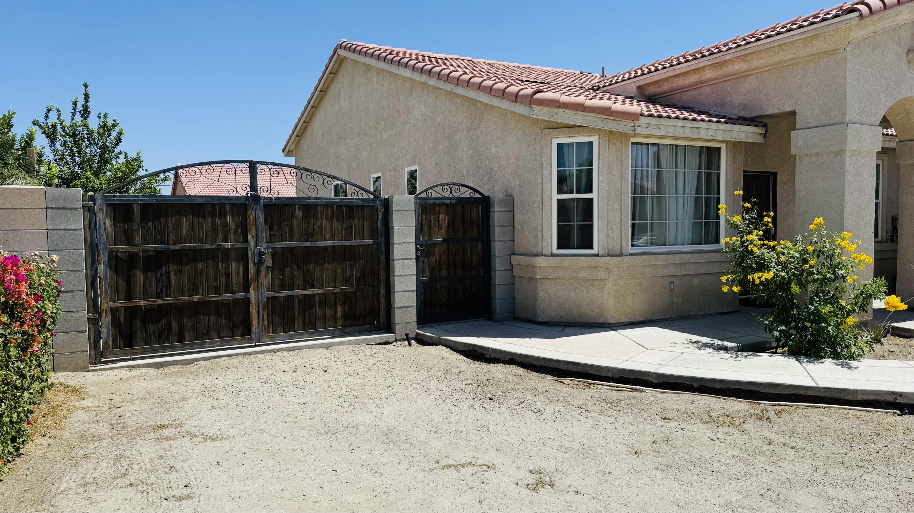 47818 Phoenix Street Indio, CA 92201 - Photo 13 of 14 a view of a house with a potted plant and a yard