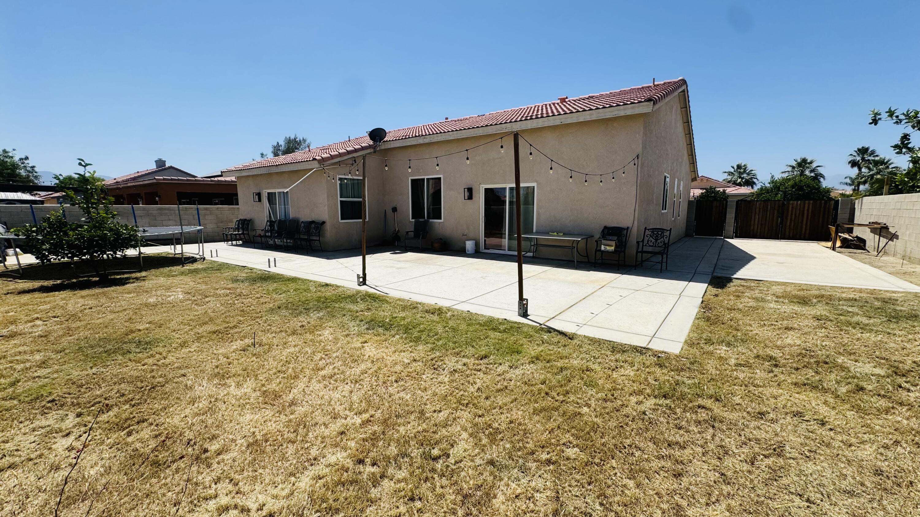 47818 Phoenix Street Indio, CA 92201 - Photo 2 of 14 a view of a house with snow on the road
