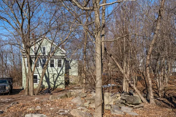a backyard of a house with lots of trees