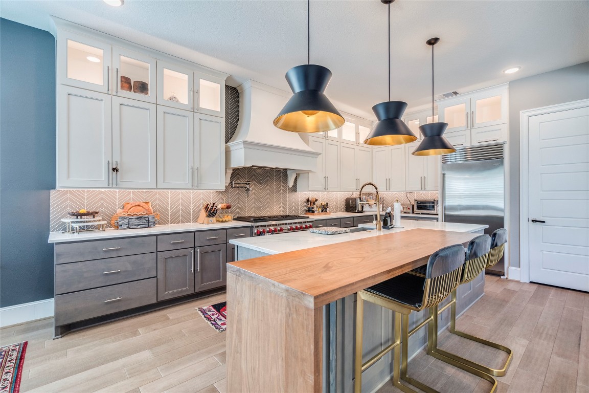 109 Bisset Court Austin, TX 78738 - Photo 11 of 34 a kitchen with a stove a window and chairs
