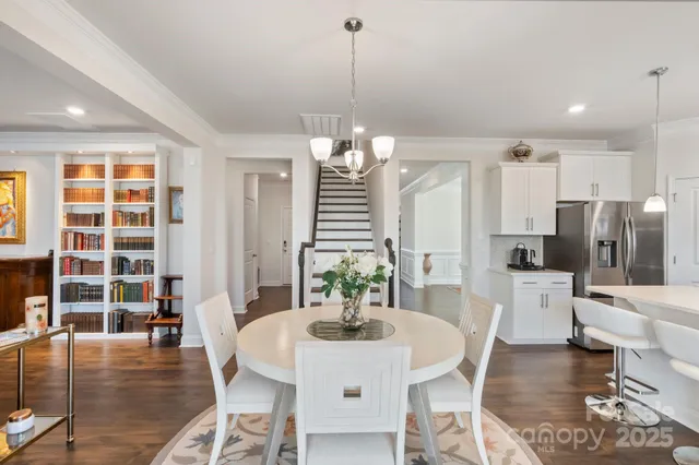 a living room with fireplace furniture and a large window
