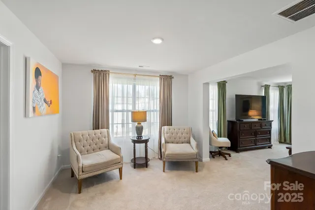 a bedroom with a bed and large windows