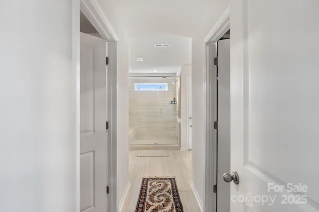 a bathroom with a tub shower and a sink