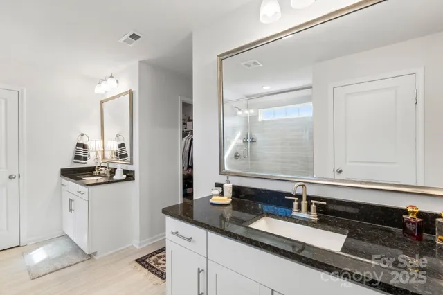 a bathroom with a glass shower door