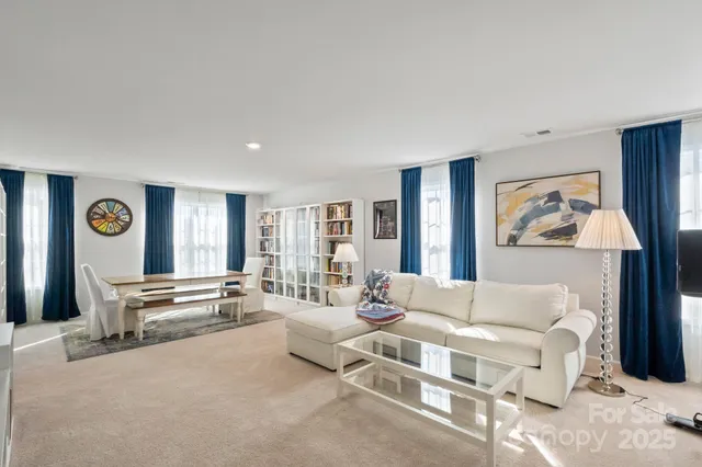a living room with furniture and a book shelf