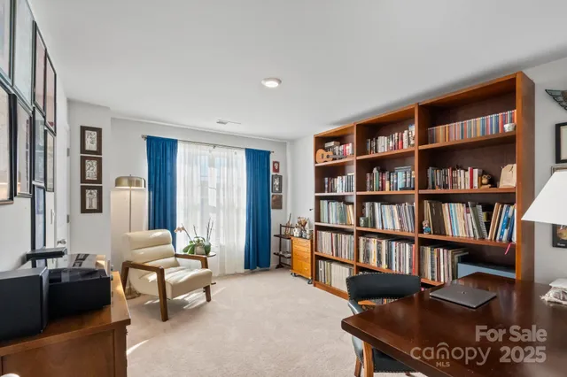 a room with furniture a small book shelf and a couch