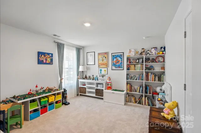 a view of room with toys and a flat screen tv