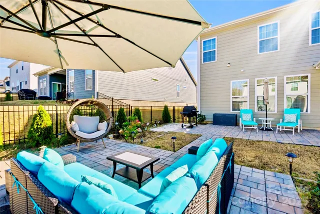 a view of a patio with couches table and chairs and potted plants