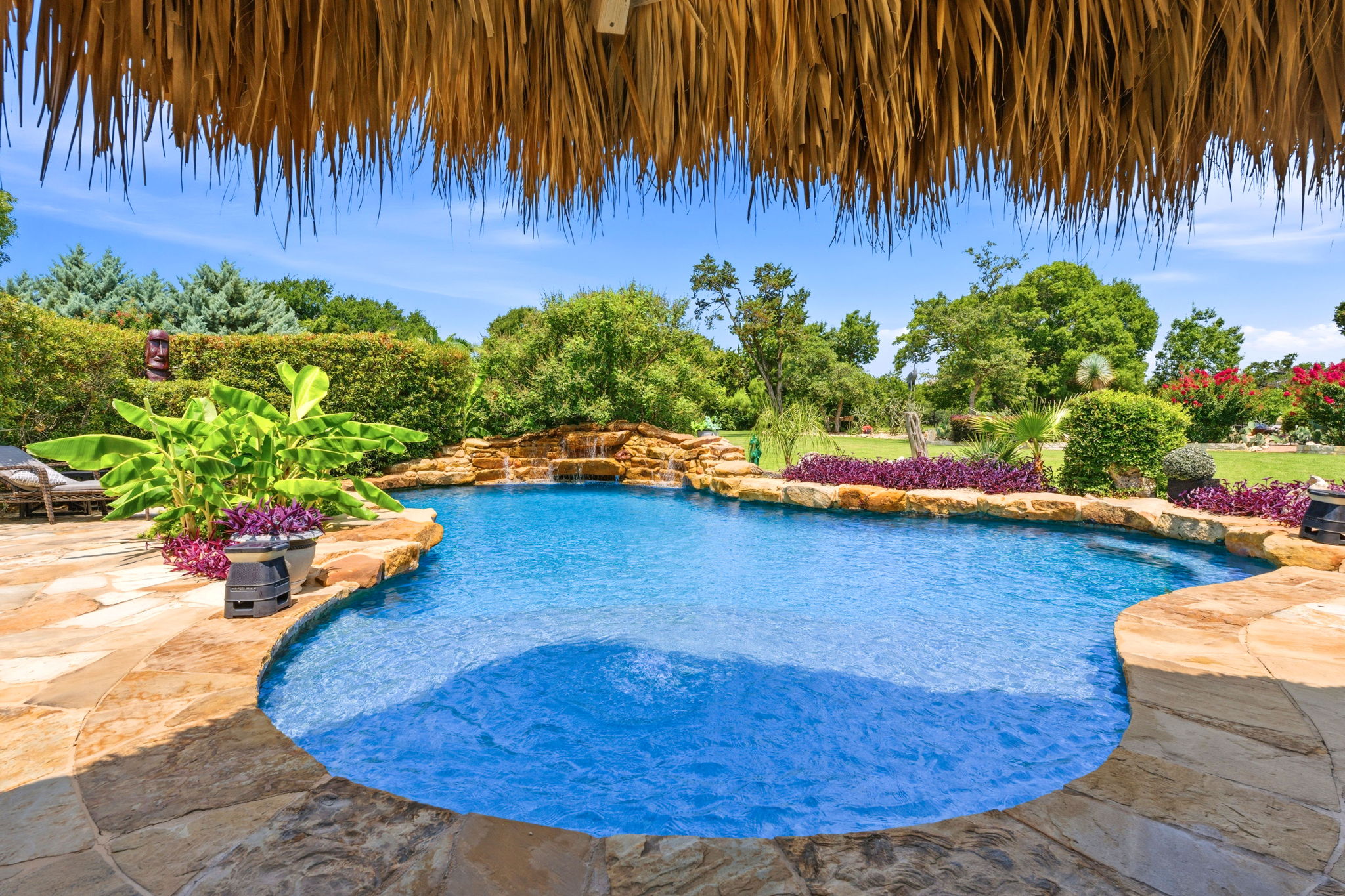 816 Brave Face Street Leander, TX 78641 - Photo 30 of 40 A tranquil oasis awaits with this sparkling pool featuring a rock waterfall and surrounding patio.