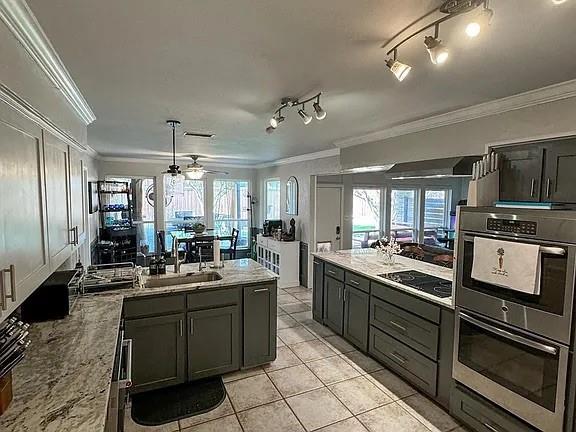 9911 Silver Creek Road Dallas, TX 75243 - Photo 8 of 28 Kitchen featuring gray cabinetry, light-toned countertops, a built-in stainless steel double oven, a smooth cooktop, and tile flooring