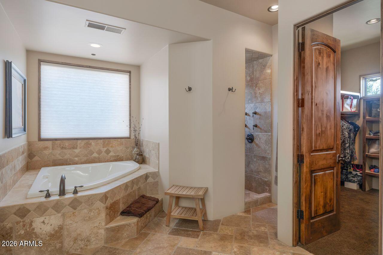 18507 East Picacho Road Rio Verde, AZ 85263 - Photo 20 of 33 a bathroom with a bathtub and a shower