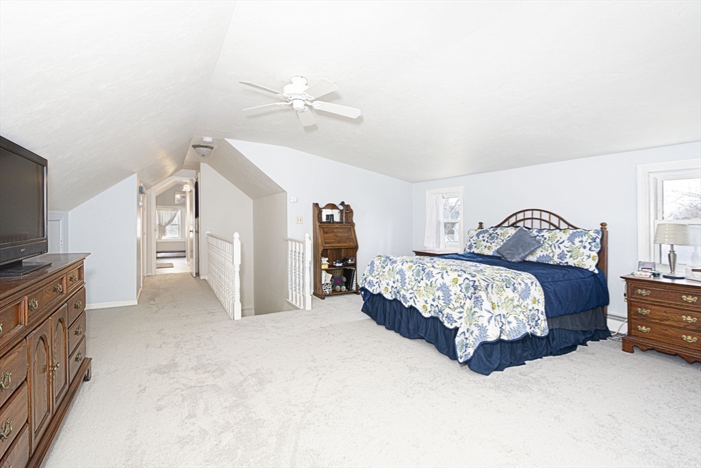 15 Monroe Street Shrewsbury, MA 01545 - Photo 13 of 30 a bedroom with a bed and a flat tv screen on dresser