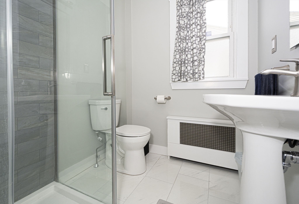 15 Monroe Street Shrewsbury, MA 01545 - Photo 20 of 30 a bathroom with a toilet a sink and a window