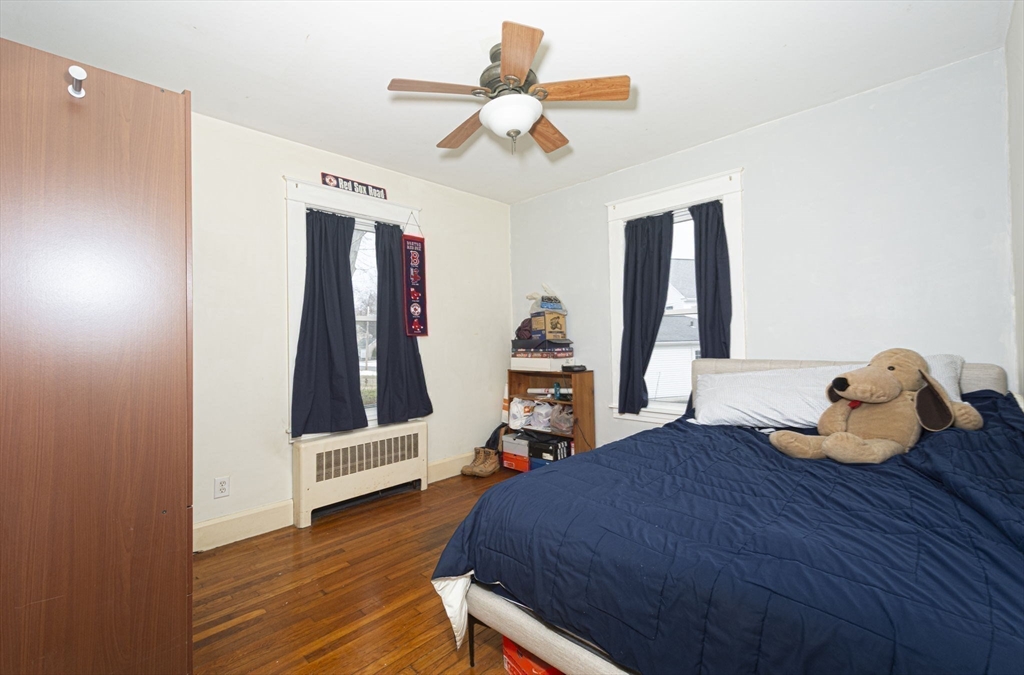 15 Monroe Street Shrewsbury, MA 01545 - Photo 22 of 30 a bedroom with a bed and wooden floor