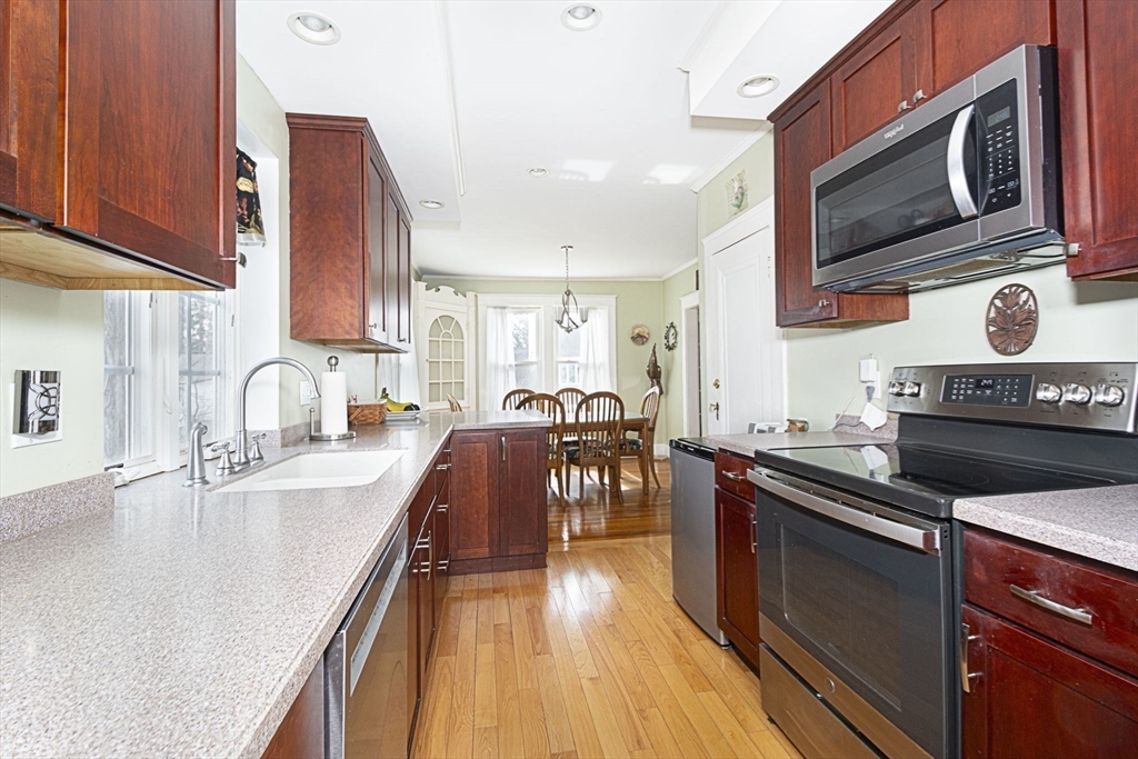 15 Monroe Street Shrewsbury, MA 01545 - Photo 9 of 30 a kitchen with stainless steel appliances granite countertop a sink stove and microwave