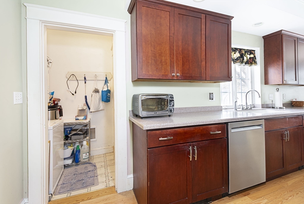 15 Monroe Street Shrewsbury, MA 01545 - Photo 10 of 30 a kitchen with wooden cabinets and a sink