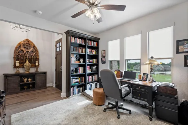 a view of a livingroom with workspace and a window