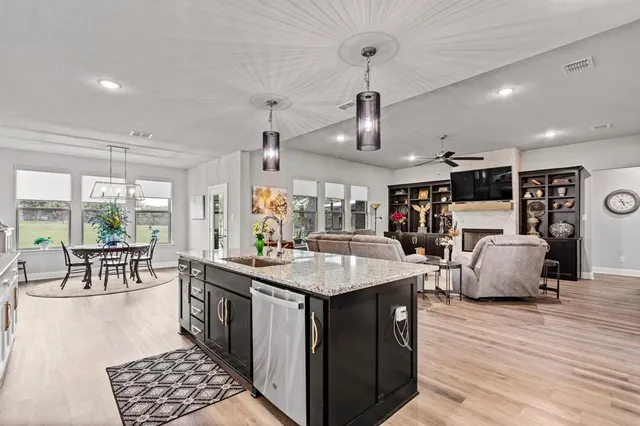a kitchen with stainless steel appliances granite countertop a sink and a stove