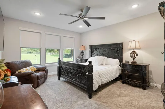 a bed room with bed and a large window