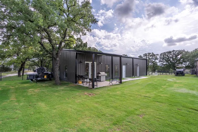 a view of a house with backyard and porch