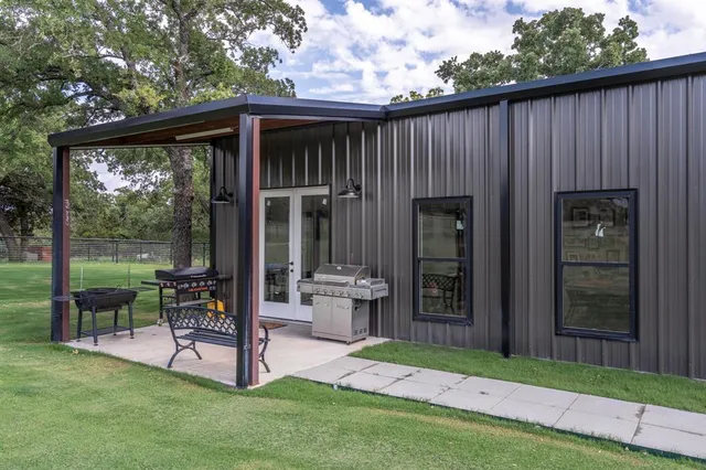 a view of a chair and table in patio with wooden fence