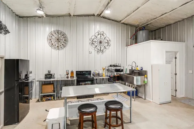 a kitchen with stainless steel appliances granite countertop a refrigerator and a stove top oven