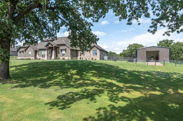 a front view of house with yard and green space