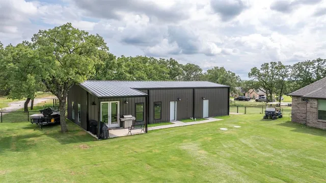 a view of a house with a yard and sitting area
