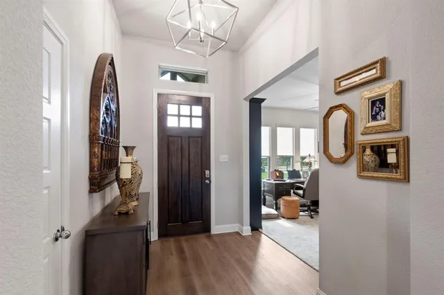 a view of a hallway with windows and closet