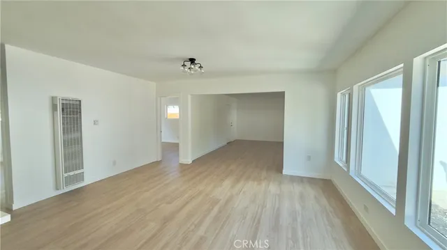 a view of a room with wooden floor and window