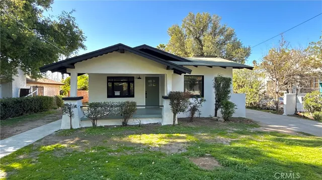 a view of a house with a yard patio and fire pit