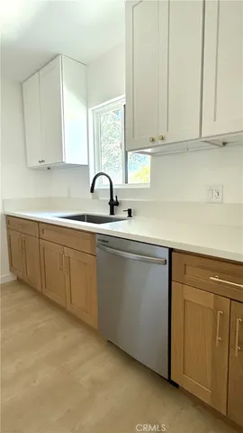 a kitchen with a sink cabinets and window
