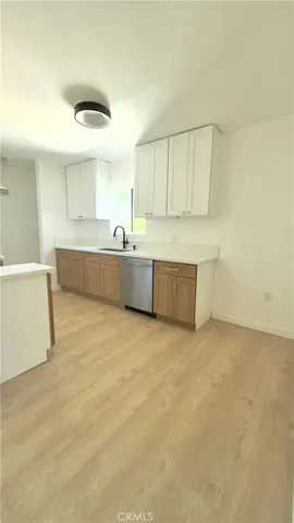 a large white kitchen with a sink