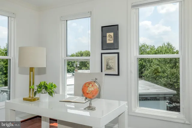 a bedroom with a bed window and a chandelier