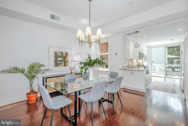 a kitchen with granite countertop a sink stove and cabinets