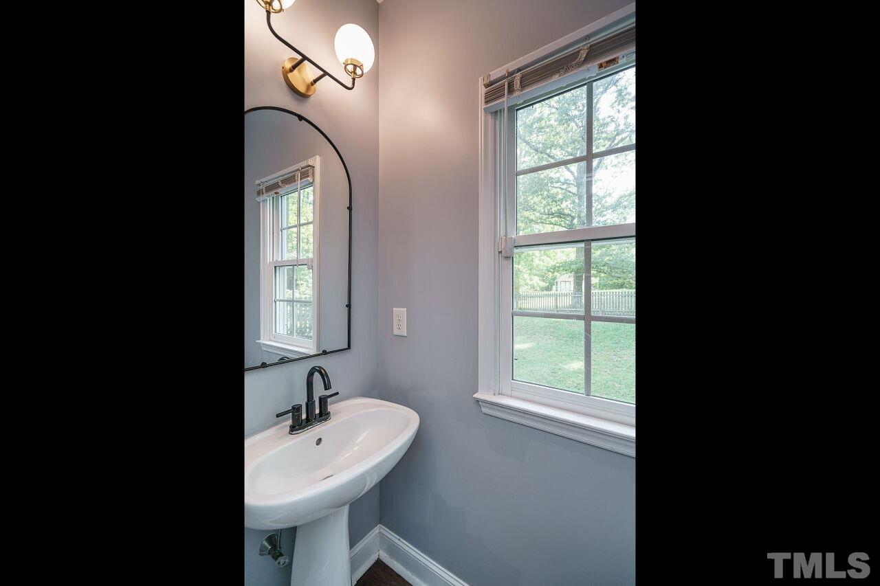 4202 Holt School Road Durham, NC 27704 - Photo 15 of 27 a bathroom with a sink and a mirror