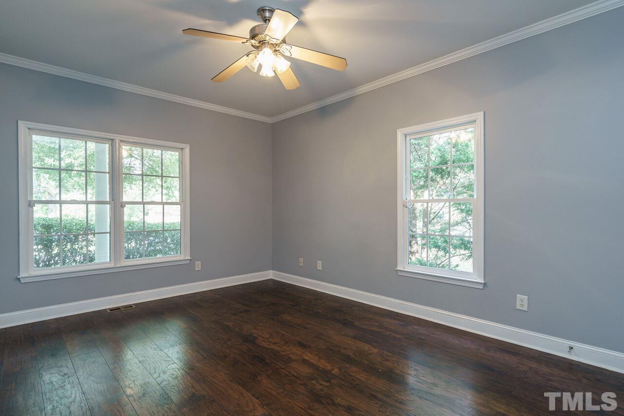 4202 Holt School Road Durham, NC 27704 - Photo 16 of 27 a view of an empty room with wooden floor and a window