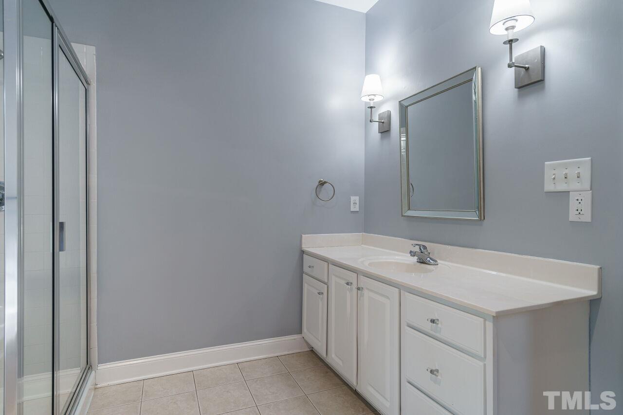 4202 Holt School Road Durham, NC 27704 - Photo 18 of 27 a bathroom with a sink and a mirror