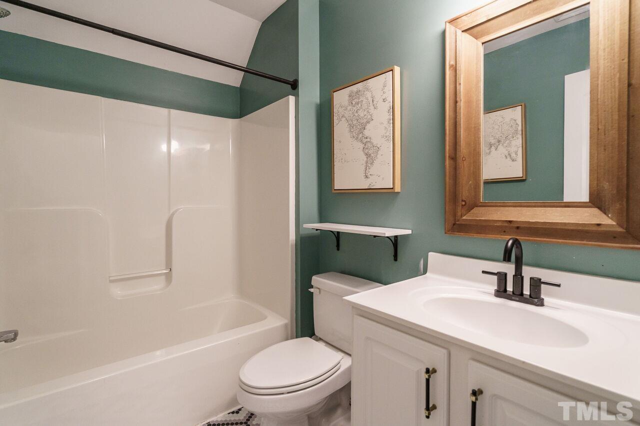4202 Holt School Road Durham, NC 27704 - Photo 21 of 27 a bathroom with a sink toilet and shower